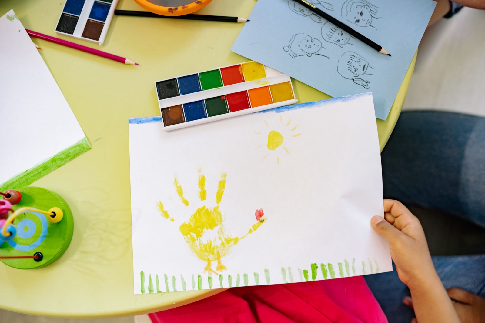 Child engaged in a watercolor painting activity, showcasing creativity and art skills.