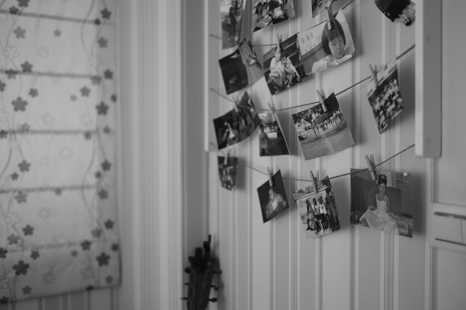Monochrome photos hanging on a string with clothespins, creating a vintage look.