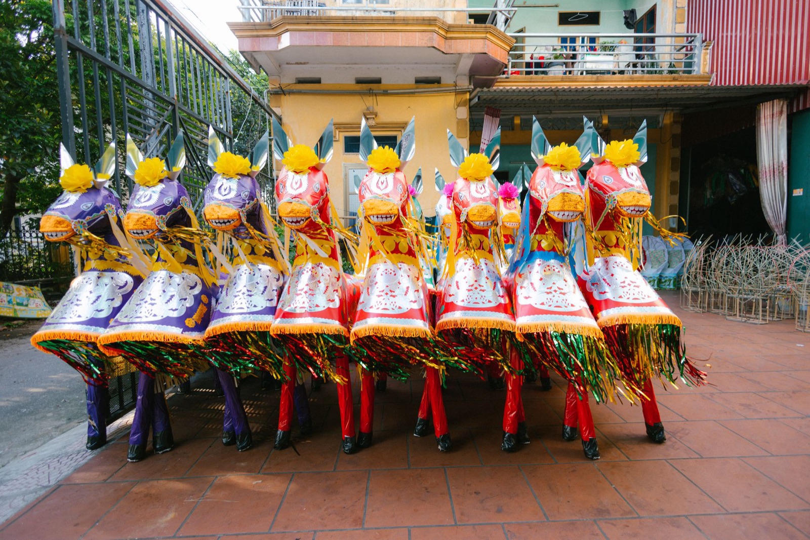Vibrant traditional puppets arranged outdoors showcasing cultural art.