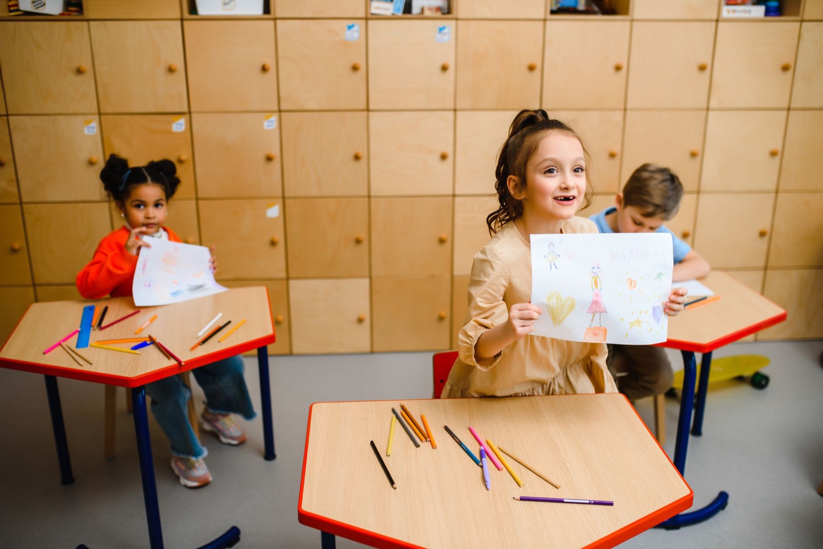Kids displaying their art creations in an engaging classroom environment.